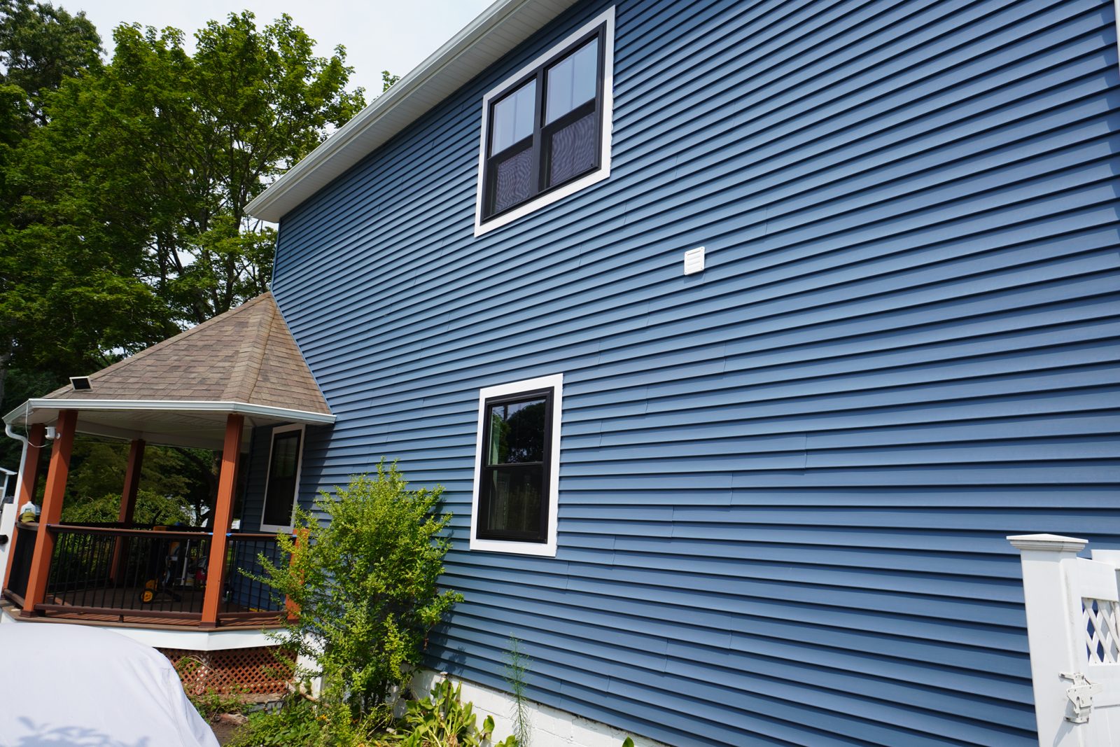 New blue vinyl siding installed across the full exterior