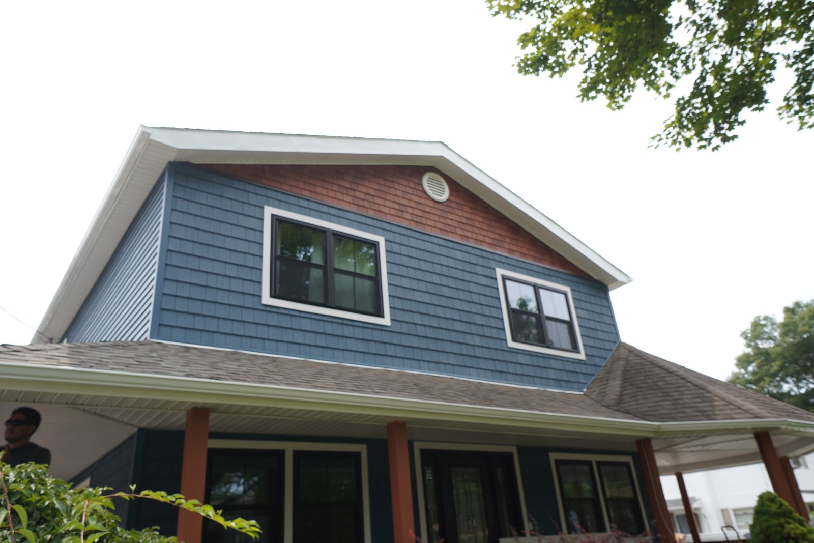 Cedar-shake gable siding with new windows and crisp white trim