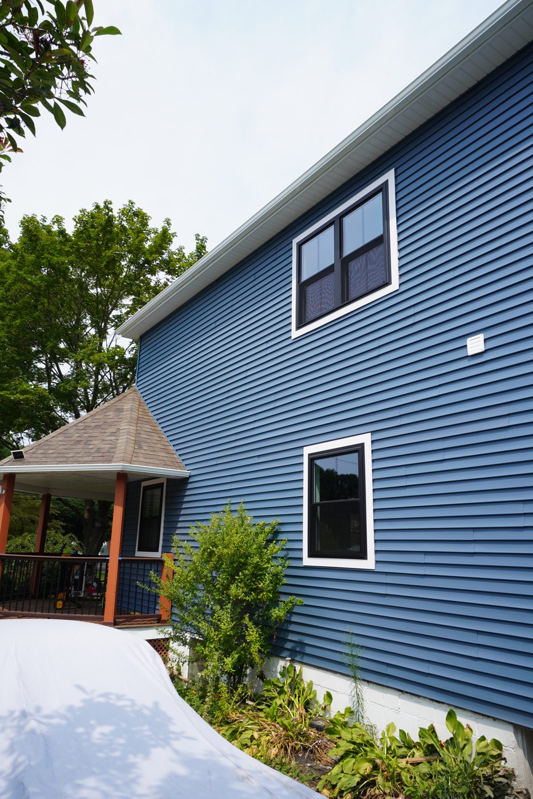 New blue siding sweeping up the roofline