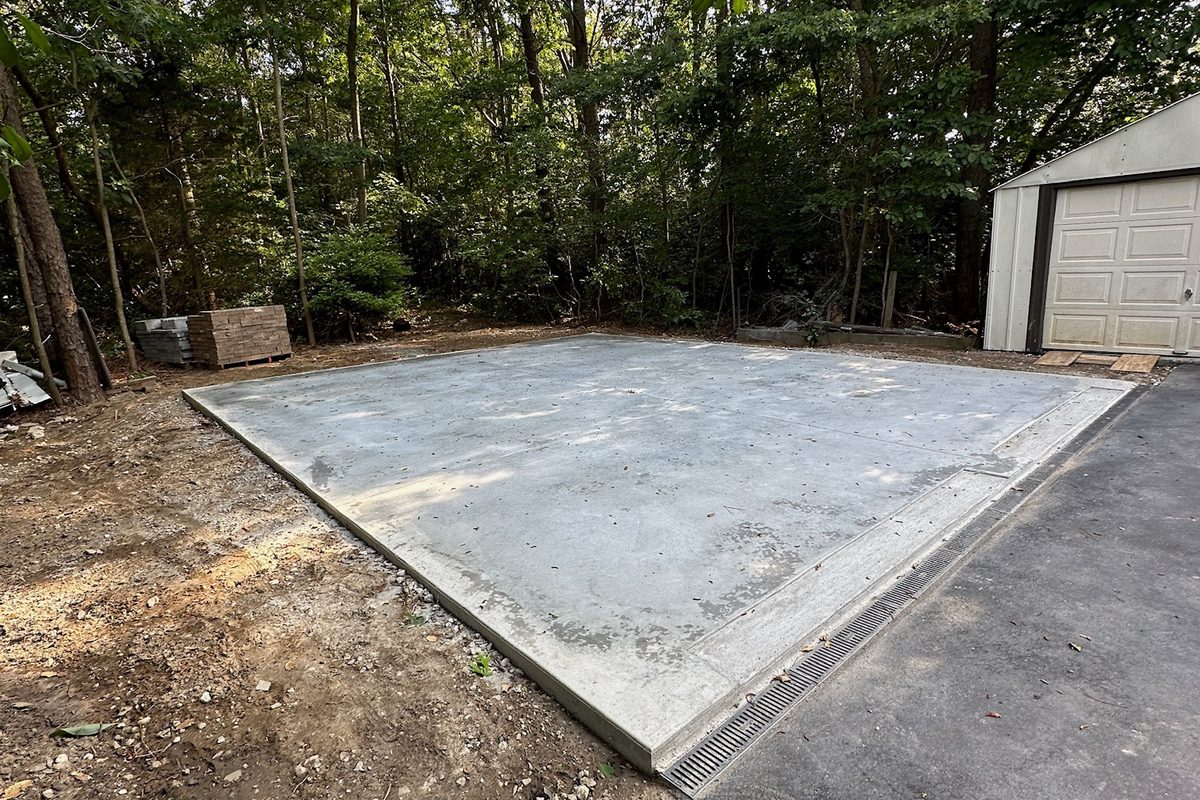 Freshly poured concrete slab foundation pad by Alec's Construction