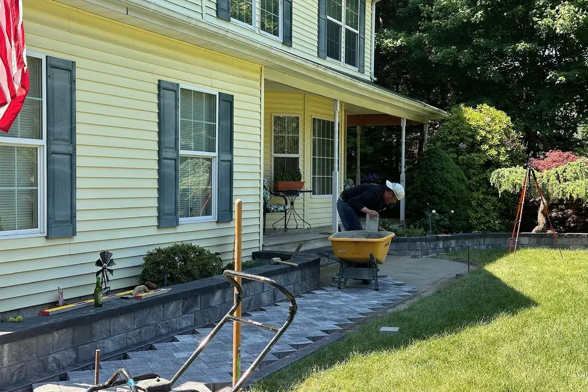 Segmental retaining walls and a paver walkway under construction by Alec's Construction