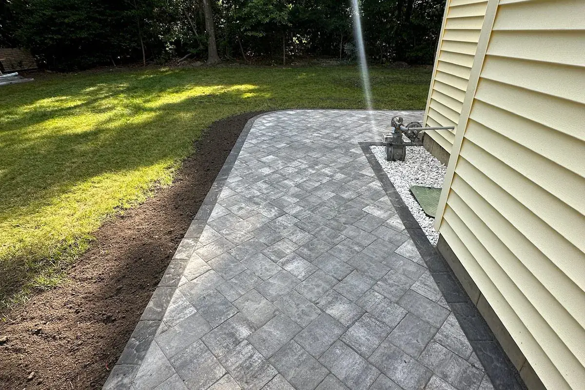 Finished herringbone paver walkway alongside a Long Island home by Alec's Construction