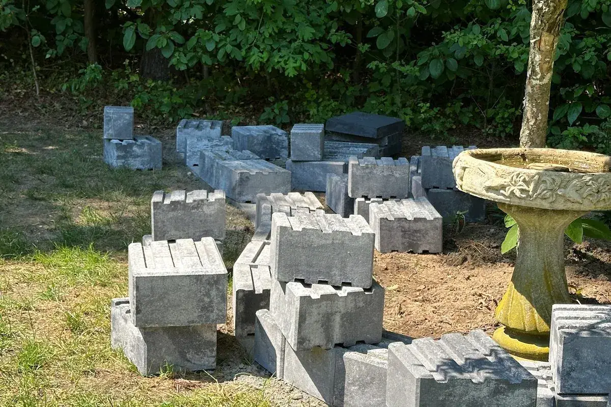 Retaining wall block staged on site by Alec's Construction on Long Island