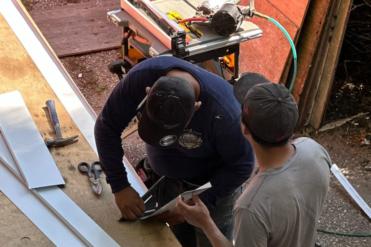 Custom metal trim being brake-formed on site by Alec's Construction