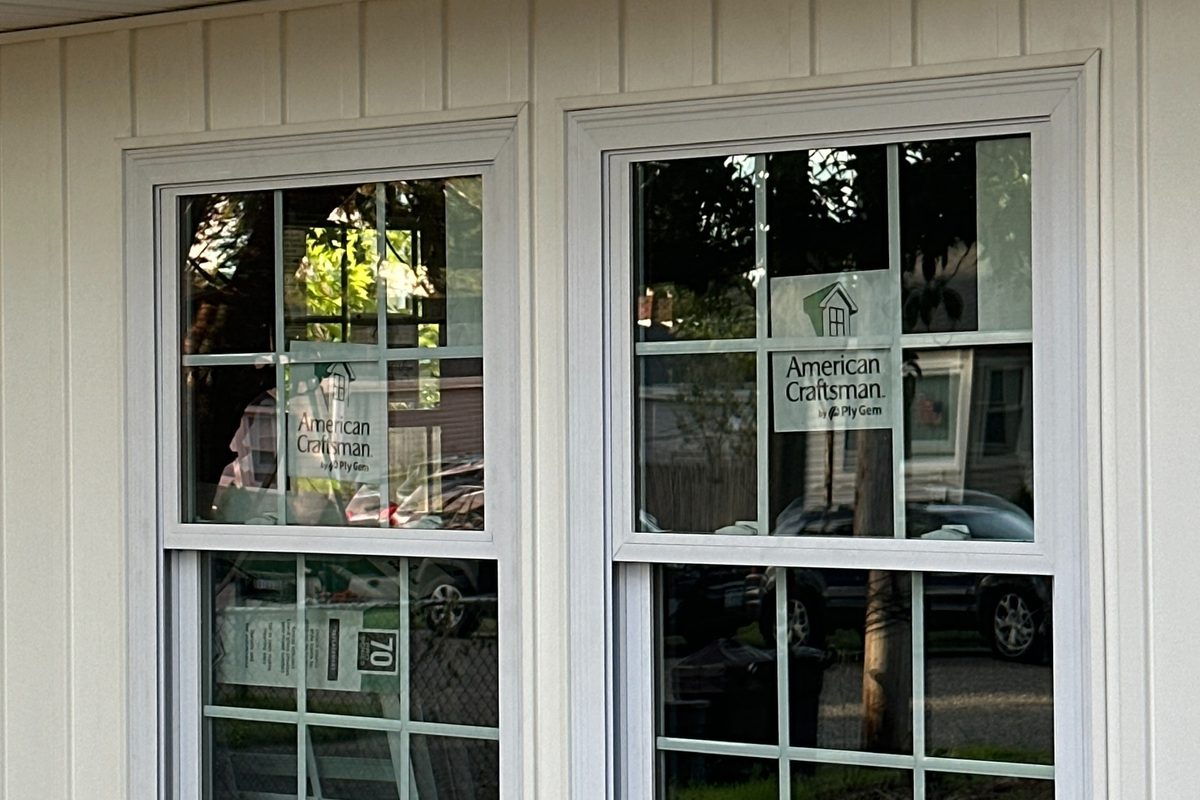 New white siding and replacement windows installed by Alec's Construction